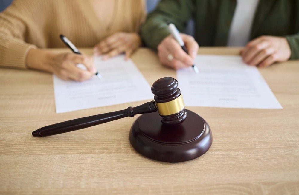 Divorce attorney reviewing financial disclosure documents with a client in a California hidden-assets case